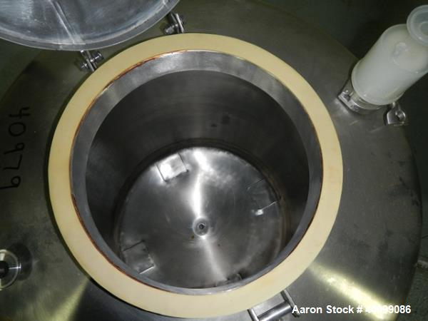 Used Tank, 75 gallon stainless steel, approximately 28" diameter x 30" straight side, dish top and bottom, 12" hand hole, 1.5", 1" top nozzles, 1" center bottom outlet on legs with 12" discharge heig...