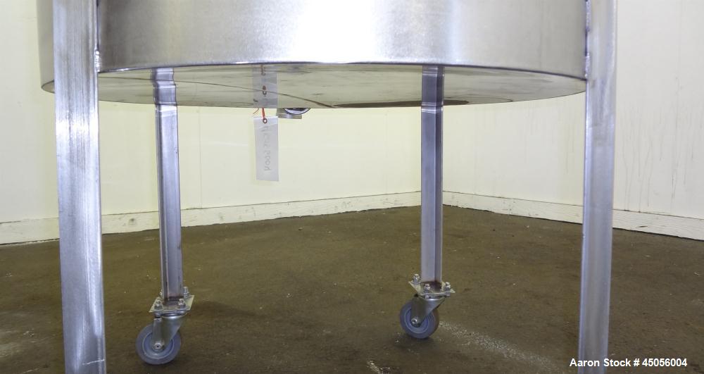 Used Tank, 80 Gallon, 304 Stainless Steel, Vertical. Approximately 30-1/2" diameter x 27" straight side, open top with (2) half hinged covers, provision for a clamp on agitator. 2" Side bottom outlet...