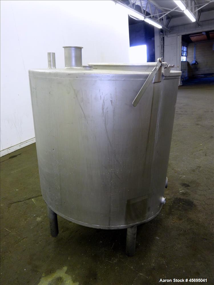Used Tank, Approximately 140 Gallon, Stainless Steel, Vertical. 36" Diameter x 34" straight side, flat top with a 1/3 hinged cover, sloped bottom. Openings top (2) 2", 2" tri-clamp, 4" tri-clamp. Sid...