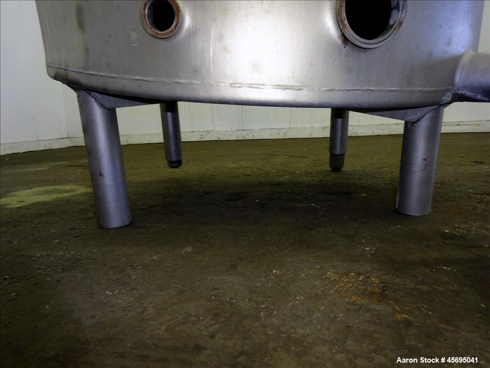 Used Tank, Approximately 140 Gallon, Stainless Steel, Vertical. 36" Diameter x 34" straight side, flat top with a 1/3 hinged cover, sloped bottom. Openings top (2) 2", 2" tri-clamp, 4" tri-clamp. Sid...