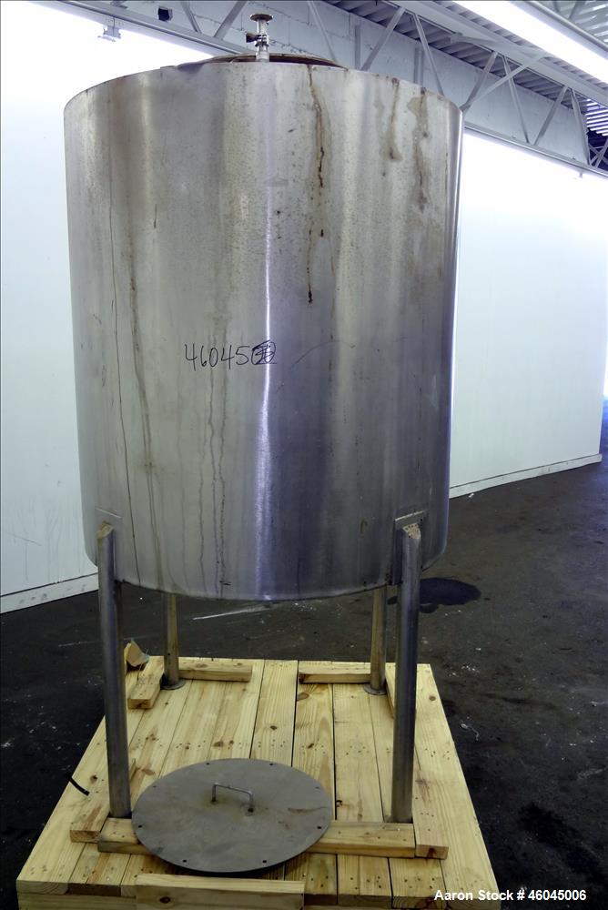 Used Tank, Approximate 330 Gallons, 304 Stainless Steel, Vertical. 45" diameter x 48" straight side, slight cone top, cone bottom. Top openings: 20" man way with cover, (3) 1" threaded, 2" threaded. ...