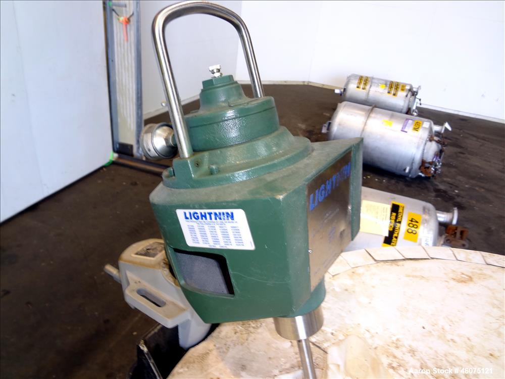 Used Tank, Approximate 300 Gallon, 304 Stainless Steel, Vertical. Approximate 44" diameter x 50" straight side, flat top, coned bottom. Off center top entering air operated Lightnin agitator model X3...
