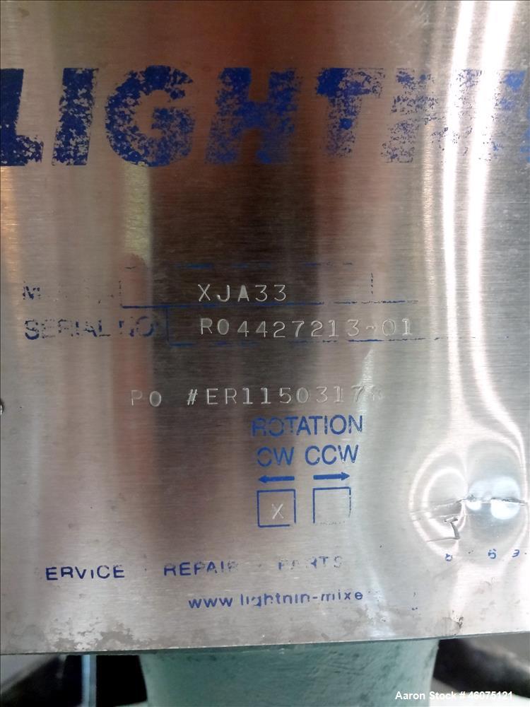 Used Tank, Approximate 300 Gallon, 304 Stainless Steel, Vertical. Approximate 44" diameter x 50" straight side, flat top, coned bottom. Off center top entering air operated Lightnin agitator model X3...
