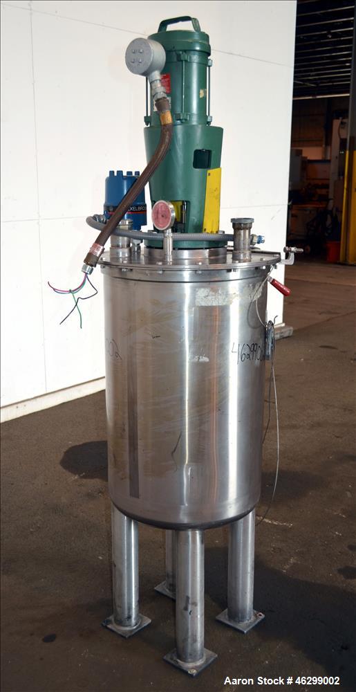 Used Tank, Approximately 40 Gallons, 304 Stainless Steel, Vertical. 20" Diameter x 30" straight side. Bolt-on flat top with 1/4 hinged cover, dished bottom. Top entering Lightnin agitator model XJC-3...