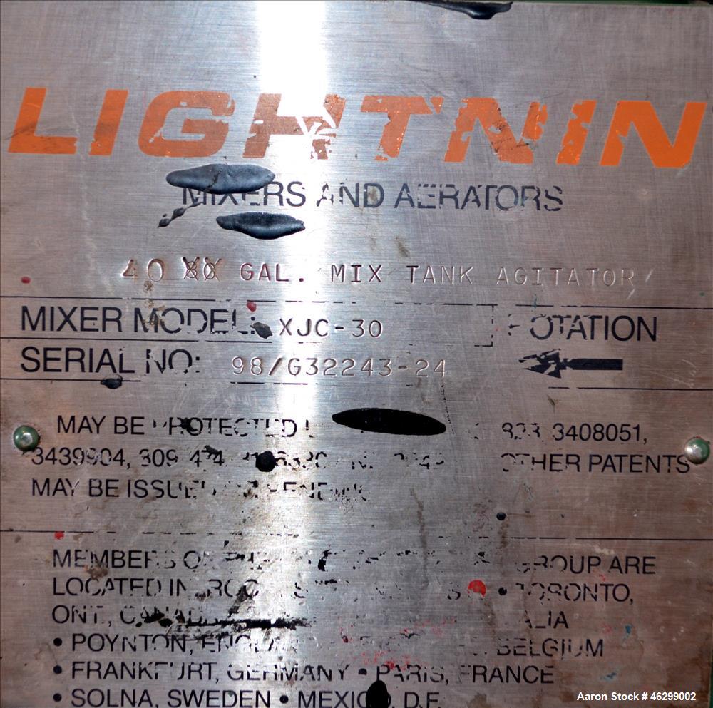 Used Tank, Approximately 40 Gallons, 304 Stainless Steel, Vertical. 20" Diameter x 30" straight side. Bolt-on flat top with 1/4 hinged cover, dished bottom. Top entering Lightnin agitator model XJC-3...