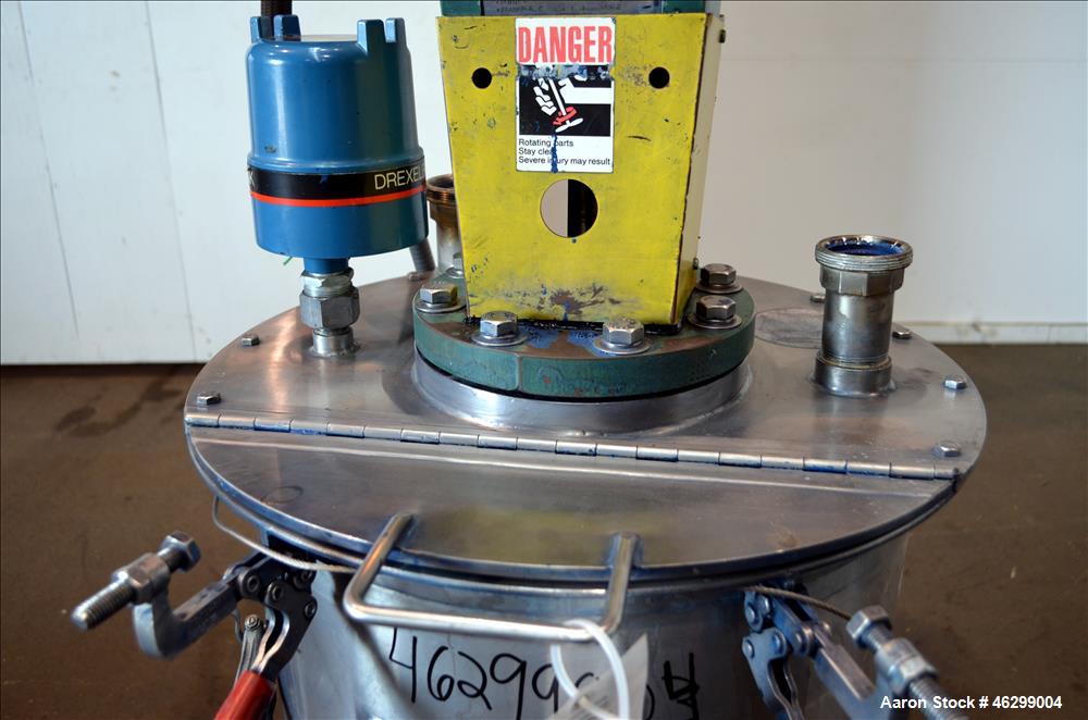 Used Tank, Approximately 40 Gallons, 304 Stainless Steel, Vertical. 20" Diameter x 30" straight side. Bolt-on flat top with 1/4 hinged cover, dished bottom. Top entering Lightnin agitator model XJC-3...