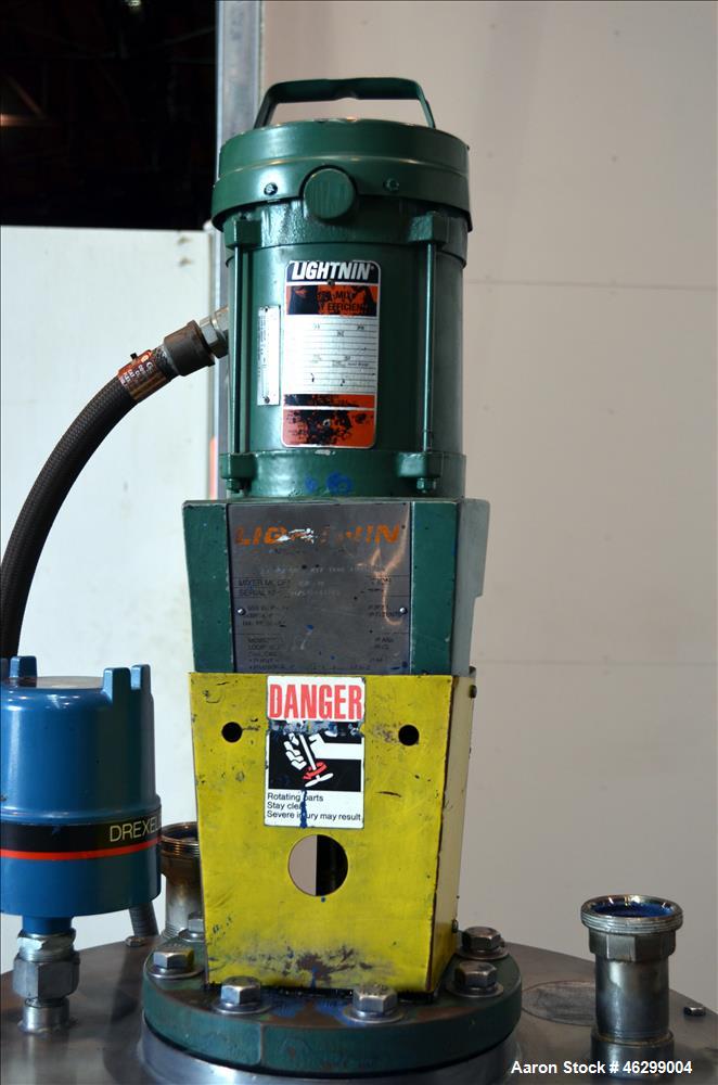 Used Tank, Approximately 40 Gallons, 304 Stainless Steel, Vertical. 20" Diameter x 30" straight side. Bolt-on flat top with 1/4 hinged cover, dished bottom. Top entering Lightnin agitator model XJC-3...