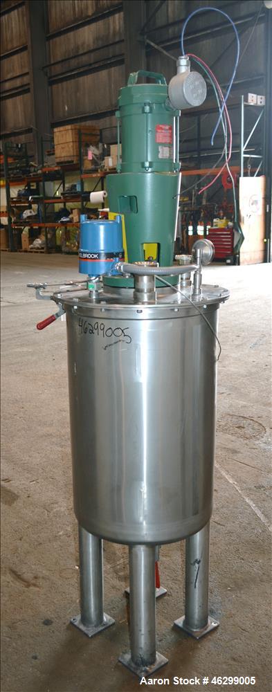 Used Tank, Approximately 40 Gallons, 304 Stainless Steel, Vertical. 20" Diameter x 30" straight side. Bolt-on flat top with 1/4 hinged cover, dished bottom. Top entering Lightnin agitator model XJC-3...