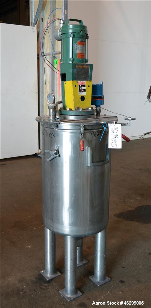 Used Tank, Approximately 40 Gallons, 304 Stainless Steel, Vertical. 20" Diameter x 30" straight side. Bolt-on flat top with 1/4 hinged cover, dished bottom. Top entering Lightnin agitator model XJC-3...