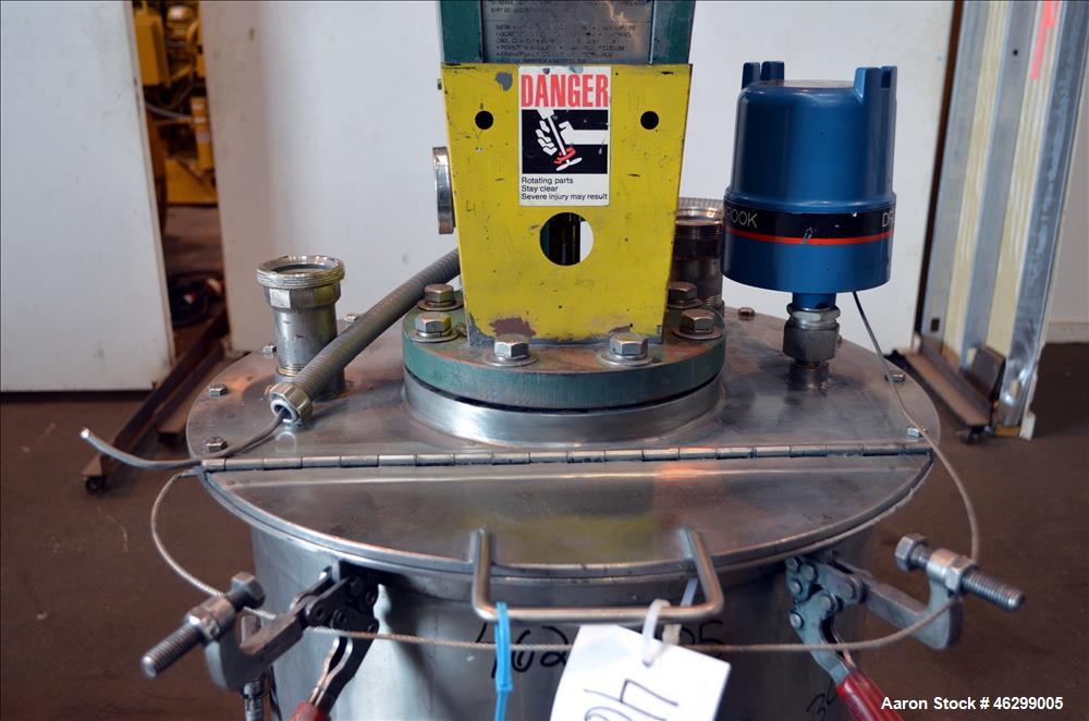 Used Tank, Approximately 40 Gallons, 304 Stainless Steel, Vertical. 20" Diameter x 30" straight side. Bolt-on flat top with 1/4 hinged cover, dished bottom. Top entering Lightnin agitator model XJC-3...