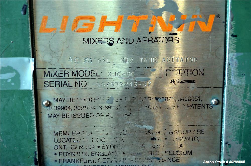 Used Tank, Approximately 40 Gallons, 304 Stainless Steel, Vertical. 20" Diameter x 30" straight side. Bolt-on flat top with 1/4 hinged cover, dished bottom. Top entering Lightnin agitator model XJC-3...