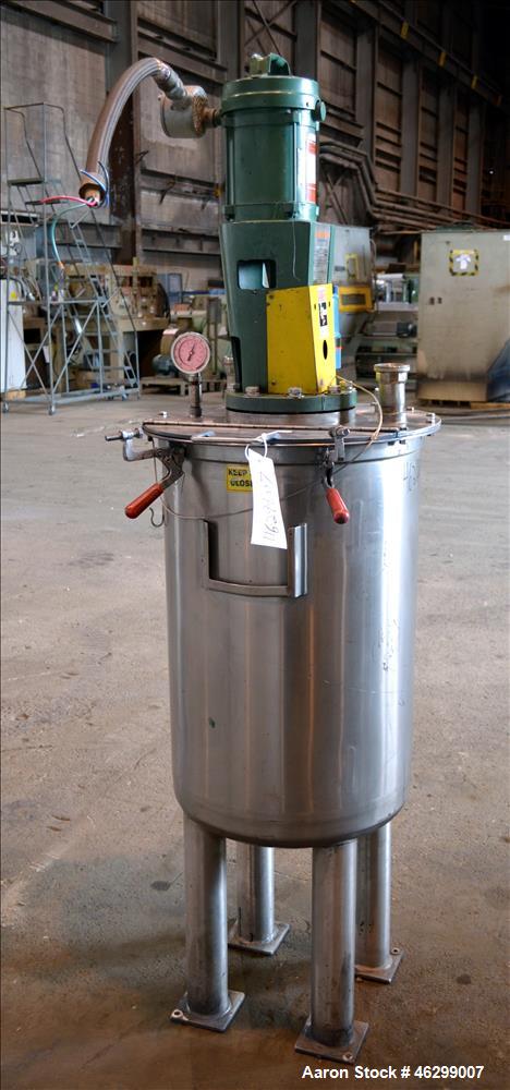 Used Tank, Approximately 40 Gallons, 304 Stainless Steel, Vertical. 20" Diameter x 30" straight side. Bolt-on flat top with 1/4 hinged cover, dished bottom. Top entering Lightnin agitator model XJC-3...