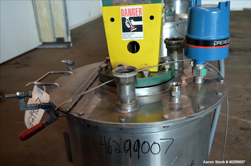 Used Tank, Approximately 40 Gallons, 304 Stainless Steel, Vertical. 20" Diameter x 30" straight side. Bolt-on flat top with 1/4 hinged cover, dished bottom. Top entering Lightnin agitator model XJC-3...
