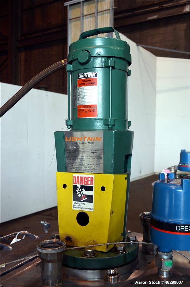 Used Tank, Approximately 40 Gallons, 304 Stainless Steel, Vertical. 20" Diameter x 30" straight side. Bolt-on flat top with 1/4 hinged cover, dished bottom. Top entering Lightnin agitator model XJC-3...