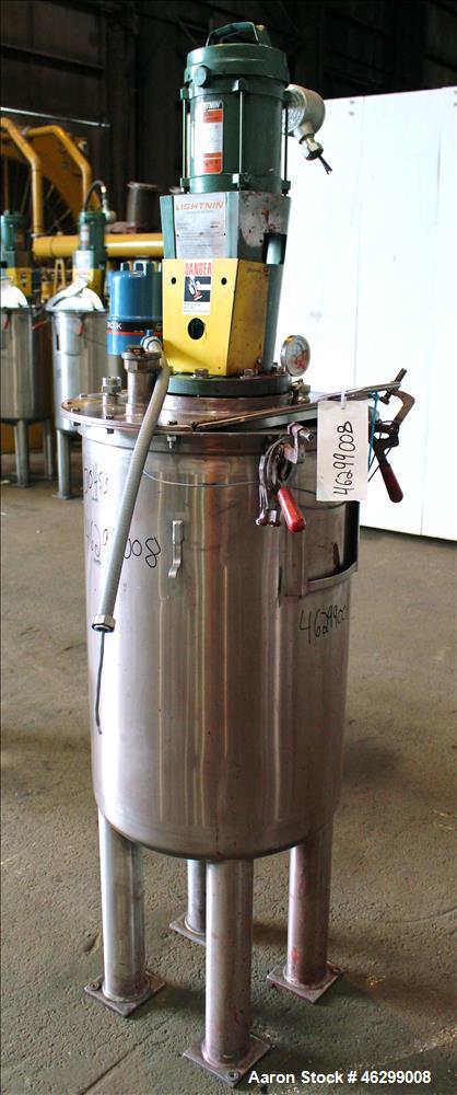 Used Tank, Approximately 40 Gallons, 304 Stainless Steel, Vertical. 20" Diameter x 30" straight side. Bolt-on flat top with 1/4 hinged cover, dished bottom. Top entering Lightnin agitator model XJC-3...