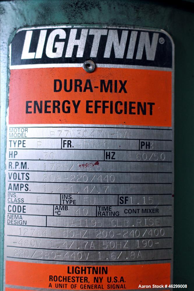Used Tank, Approximately 40 Gallons, 304 Stainless Steel, Vertical. 20" Diameter x 30" straight side. Bolt-on flat top with 1/4 hinged cover, dished bottom. Top entering Lightnin agitator model XJC-3...