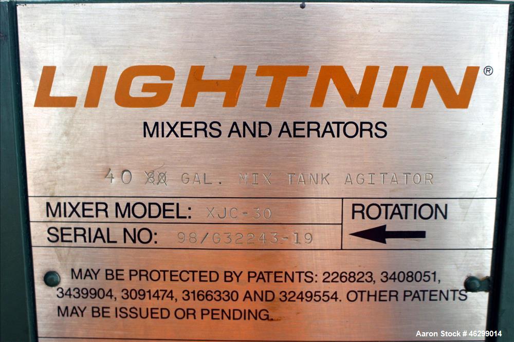 Used Tank, Approximately 40 Gallons, 304 Stainless Steel, Vertical. 20" Diameter x 30" straight side. Bolt-on flat top with 1/4 hinged cover, dished bottom. Top entering Lightnin agitator model XJC-3...