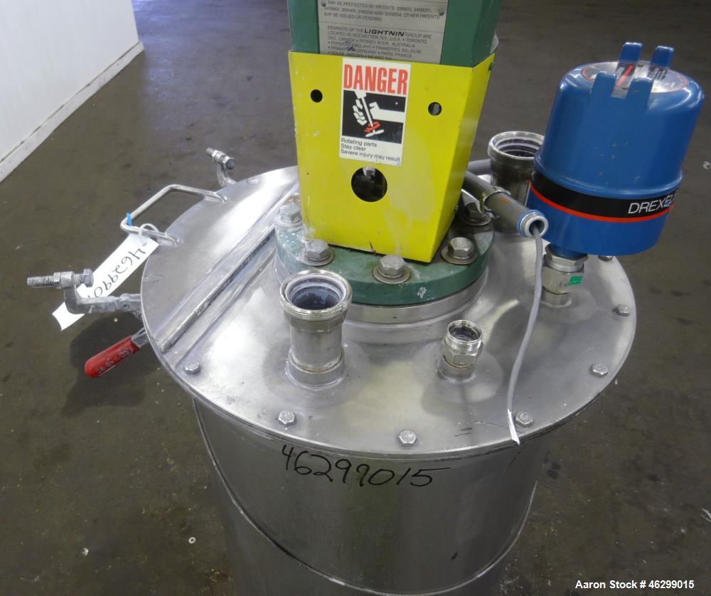 Used Tank, Approximately 40 Gallons, 304 Stainless Steel, Vertical. 20" Diameter x 30" straight side. Bolt-on flat top with 1/4 hinged cover, dished bottom. Top entering Lightnin agitator model XJC-3...