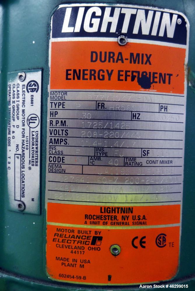 Used Tank, Approximately 40 Gallons, 304 Stainless Steel, Vertical. 20" Diameter x 30" straight side. Bolt-on flat top with 1/4 hinged cover, dished bottom. Top entering Lightnin agitator model XJC-3...