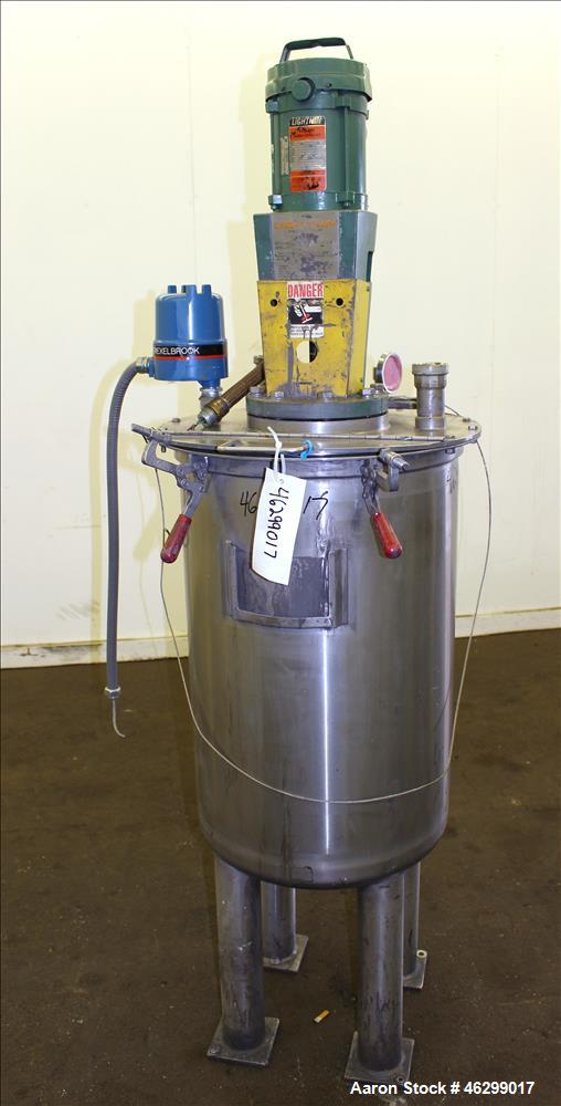 Used Tank, Approximately 40 Gallons, 304 Stainless Steel, Vertical. 20" Diameter x 30" straight side. Bolt-on flat top with 1/4 hinged cover, dished bottom. Top entering Lightnin agitator model XJC-3...