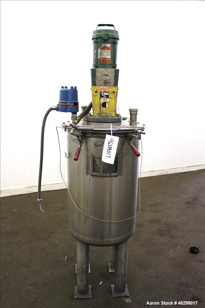 Used Tank, Approximately 40 Gallons, 304 Stainless Steel, Vertical. 20" Diameter x 30" straight side. Bolt-on flat top with 1/4 hinged cover, dished bottom. Top entering Lightnin agitator model XJC-3...