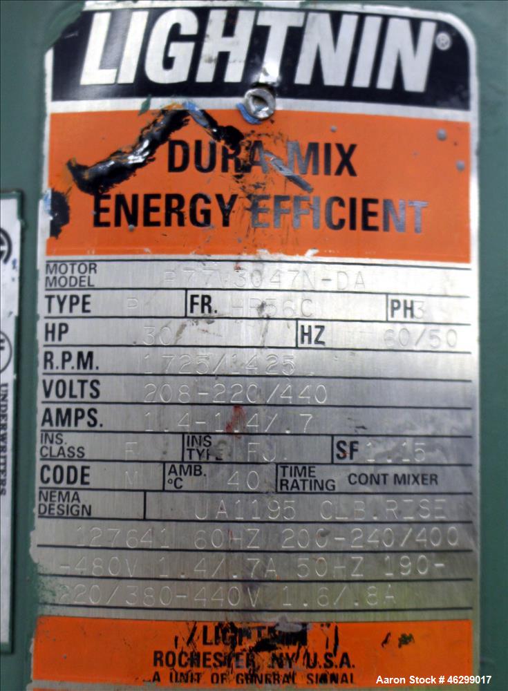 Used Tank, Approximately 40 Gallons, 304 Stainless Steel, Vertical. 20" Diameter x 30" straight side. Bolt-on flat top with 1/4 hinged cover, dished bottom. Top entering Lightnin agitator model XJC-3...