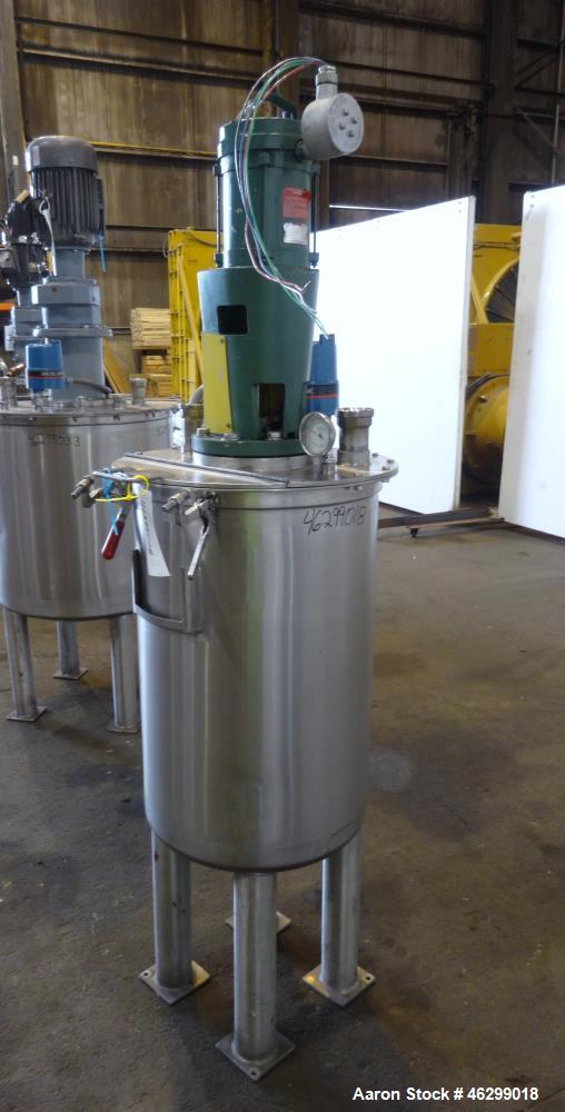 Used Tank, Approximately 40 Gallons, 304 Stainless Steel, Vertical. 20" Diameter x 30" straight side. Bolt-on flat top with 1/4 hinged cover, dished bottom. Top entering Lightnin agitator model XJC-3...