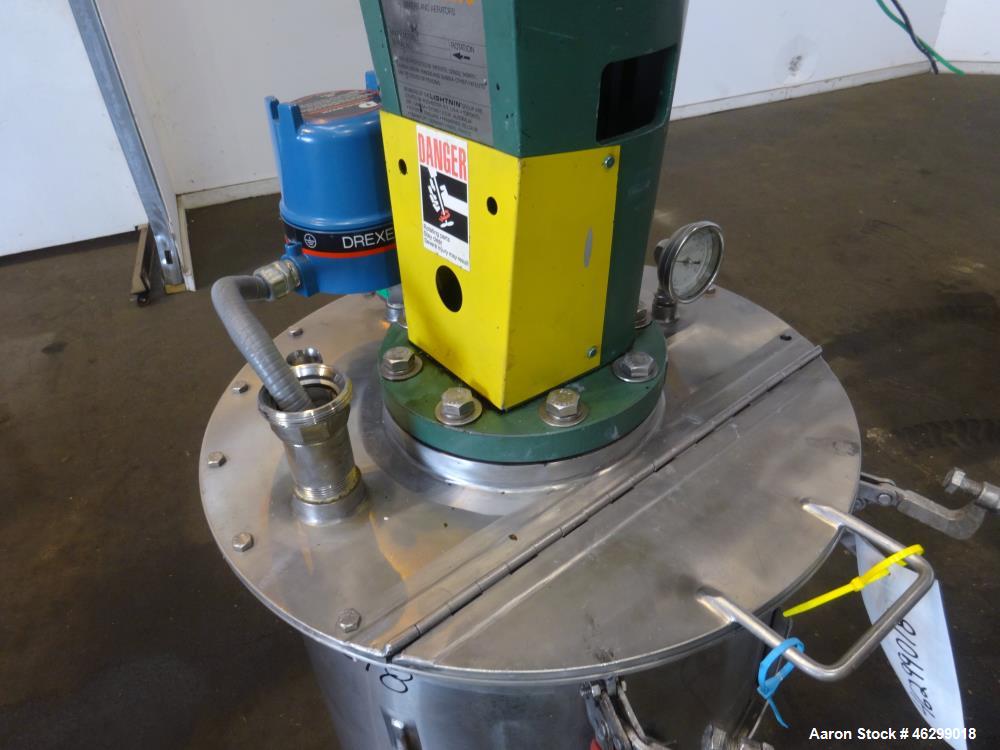 Used Tank, Approximately 40 Gallons, 304 Stainless Steel, Vertical. 20" Diameter x 30" straight side. Bolt-on flat top with 1/4 hinged cover, dished bottom. Top entering Lightnin agitator model XJC-3...