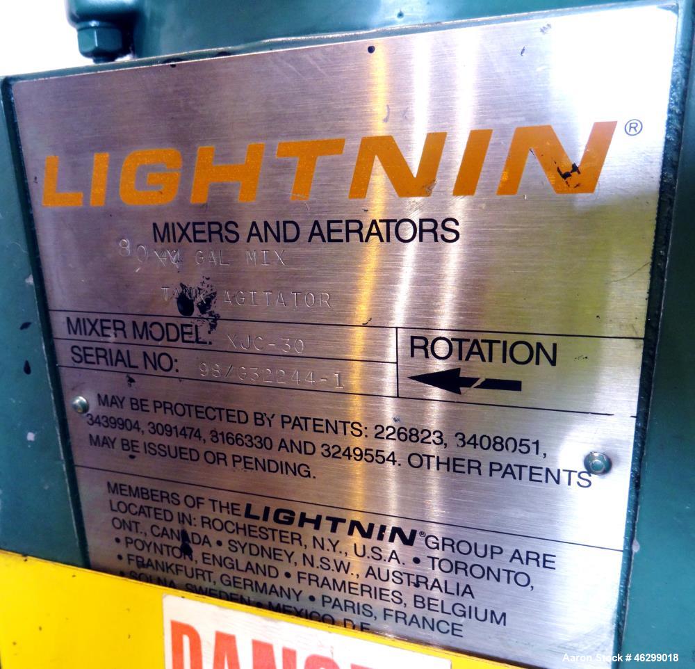 Used Tank, Approximately 40 Gallons, 304 Stainless Steel, Vertical. 20" Diameter x 30" straight side. Bolt-on flat top with 1/4 hinged cover, dished bottom. Top entering Lightnin agitator model XJC-3...