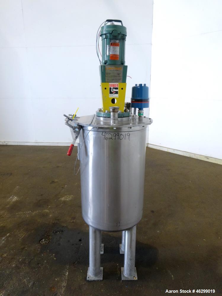 Used Tank, Approximately 40 Gallons, 304 Stainless Steel, Vertical. 20" Diameter x 30" straight side. Bolt-on flat top with 1/4 hinged cover, dished bottom. Top entering Lightnin agitator model XJC-3...