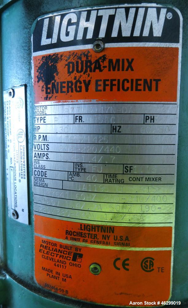 Used Tank, Approximately 40 Gallons, 304 Stainless Steel, Vertical. 20" Diameter x 30" straight side. Bolt-on flat top with 1/4 hinged cover, dished bottom. Top entering Lightnin agitator model XJC-3...