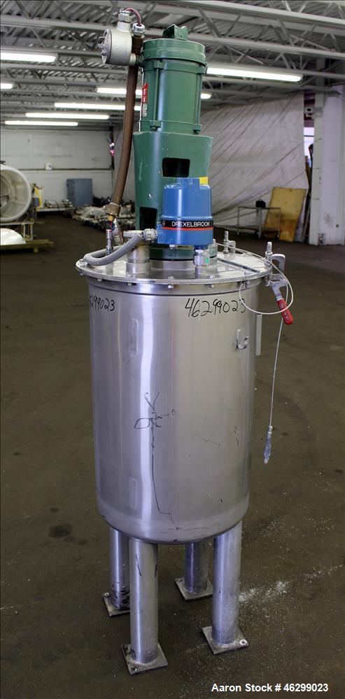 Used Tank, Approximately 40 Gallons, 304 Stainless Steel, Vertical. 20" Diameter x 30" straight side. Bolt-on flat top with 1/4 hinged cover, dished bottom. Top entering Lightnin agitator model XJC-3...