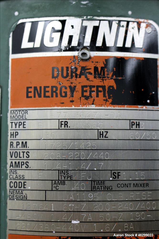 Used Tank, Approximately 40 Gallons, 304 Stainless Steel, Vertical. 20" Diameter x 30" straight side. Bolt-on flat top with 1/4 hinged cover, dished bottom. Top entering Lightnin agitator model XJC-3...