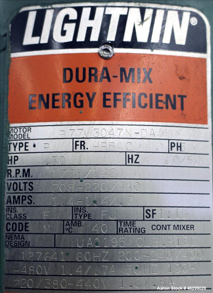 Used Tank, Approximately 40 Gallons, 304 Stainless Steel, Vertical. 20" Diameter x 30" straight side. Bolt-on flat top with 1/4 hinged cover, dished bottom. Top entering Lightnin agitator model XJC-3...