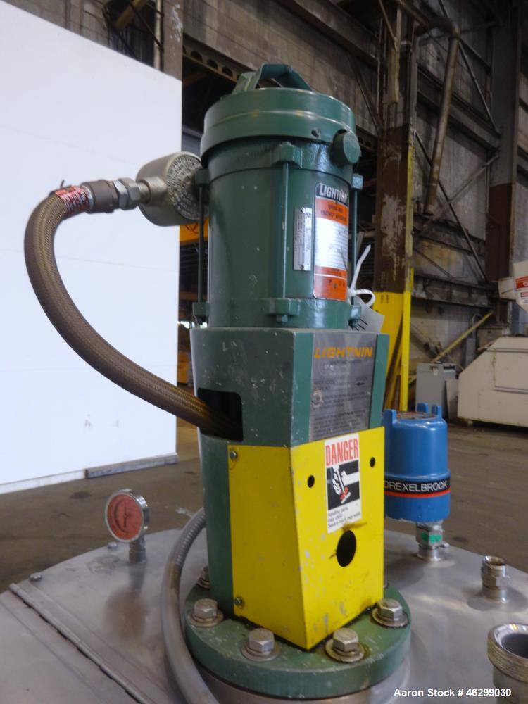 Used Tank, Approximately 80 Gallons, 304 Stainless Steel, Vertical. 30" Diameter x 28" straight side. Bolt-on flat top with 1/3 hinged cover, dished bottom. Top entering Lightnin agitator model XJC-3...