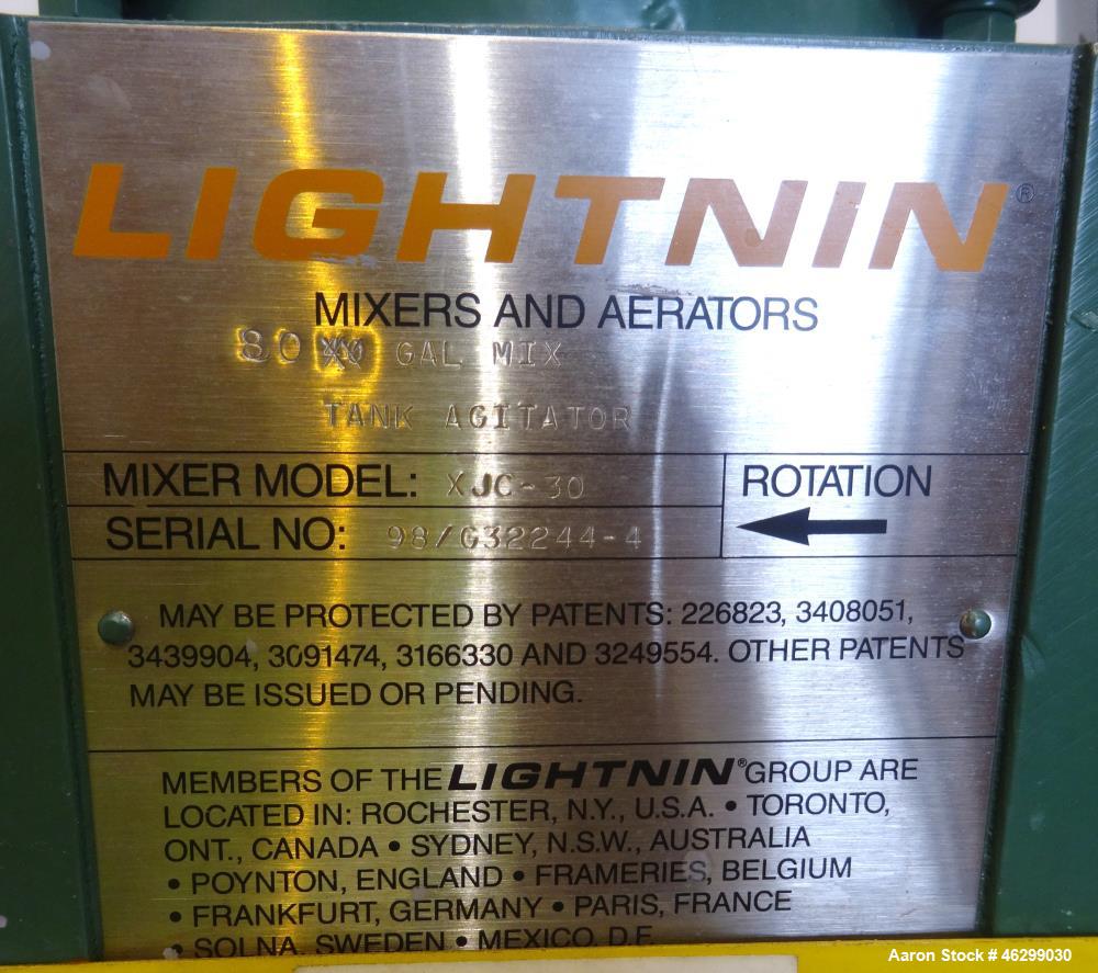 Used Tank, Approximately 80 Gallons, 304 Stainless Steel, Vertical. 30" Diameter x 28" straight side. Bolt-on flat top with 1/3 hinged cover, dished bottom. Top entering Lightnin agitator model XJC-3...