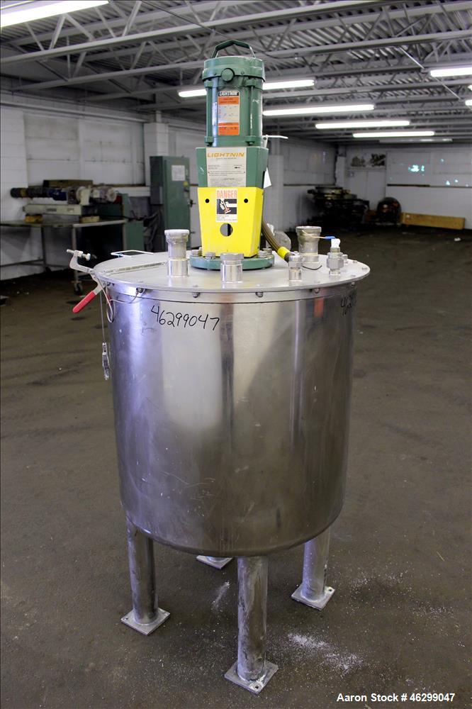 Used Tank, Approximately 80 Gallons, 304 Stainless Steel, Vertical. 30" Diameter x 28" straight side. Bolt on flat top with 1/3 hinged cover, dished bottom. Top entering Lightnin agitator model XJC-3...