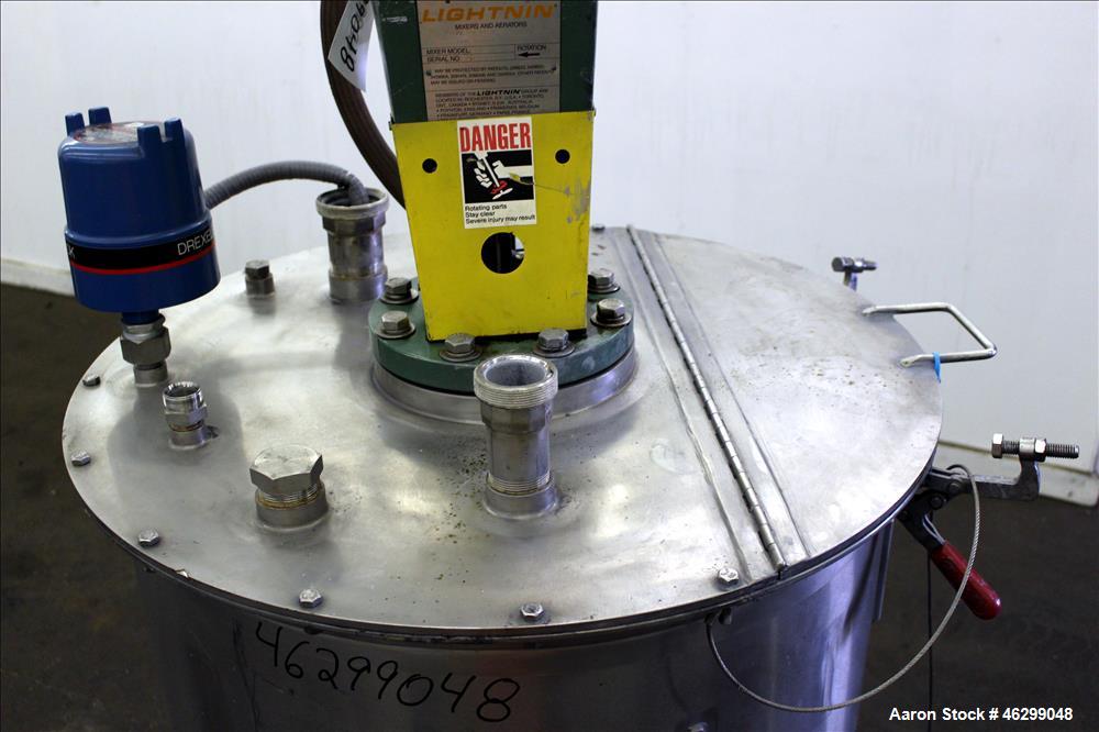 Used Tank, Approximately 80 Gallons, 304 Stainless Steel, Vertical. 30" Diameter x 28" straight side. Bolt-on flat top with 1/3 hinged cover, dished bottom. Top entering Lightnin agitator model XJC-3...
