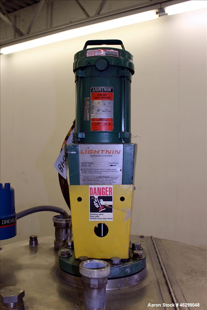 Used Tank, Approximately 80 Gallons, 304 Stainless Steel, Vertical. 30" Diameter x 28" straight side. Bolt-on flat top with 1/3 hinged cover, dished bottom. Top entering Lightnin agitator model XJC-3...