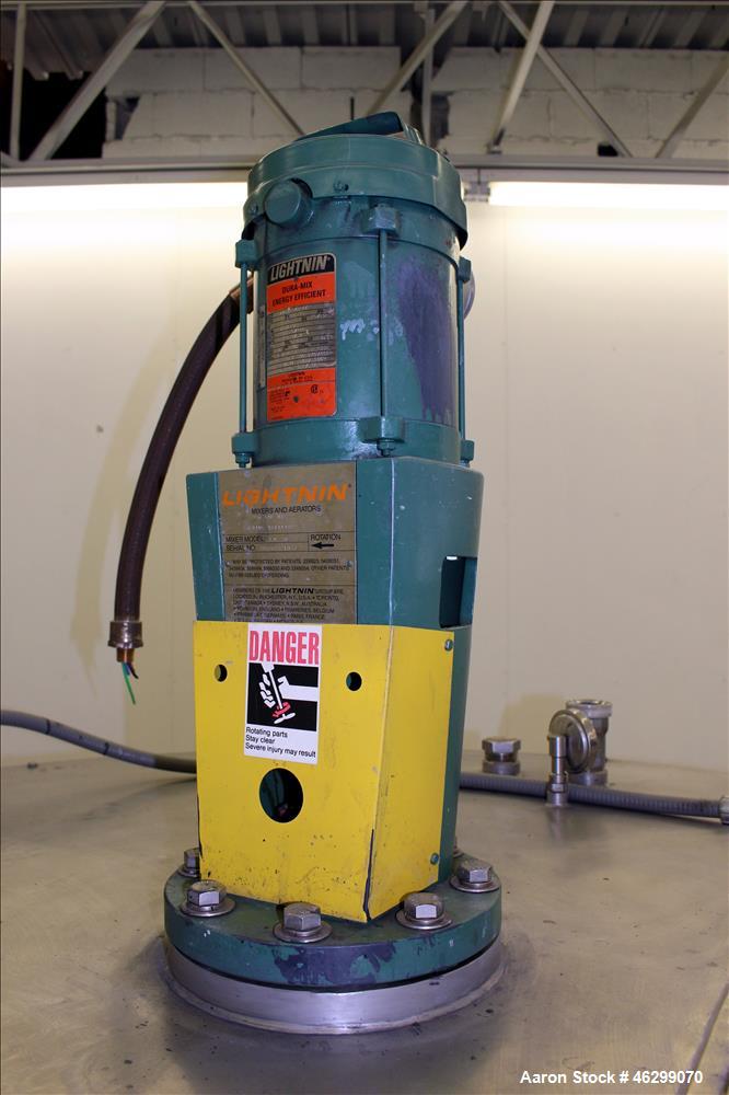 Used Tank, Approximately 350 Gallons, 304 Stainless Steel, Vertical. 60" Diameter x 28" straight side. Bolt-on flat top with 1/3 hinged cover, dished bottom. Top entering Lightnin agitator, model XJC...