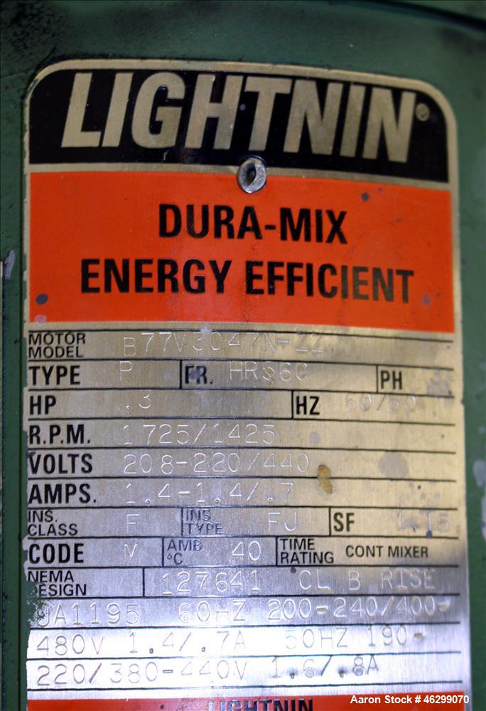 Used Tank, Approximately 350 Gallons, 304 Stainless Steel, Vertical. 60" Diameter x 28" straight side. Bolt-on flat top with 1/3 hinged cover, dished bottom. Top entering Lightnin agitator, model XJC...