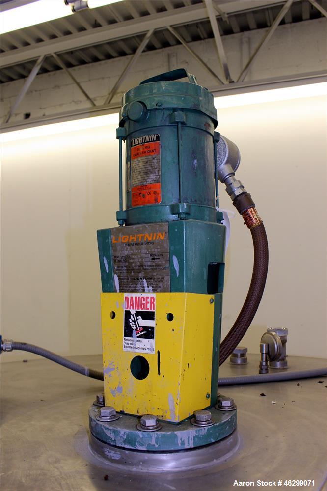 Used Tank, Approximately 350 Gallons, 304 Stainless Steel, Vertical. 60" Diameter x 28" straight side. Bolt-on flat top with 1/3 hinged cover, dished bottom. Top entering Lightnin agitator, model XJC...