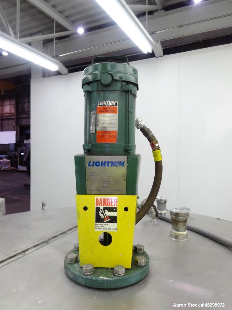 Used Tank, Approximately 350 Gallons, 304 Stainless Steel, Vertical. 60" Diameter x 28" straight side. Bolt-on flat top with 1/3 hinged cover, dished bottom. Top entering Lightnin agitator, model XJC...