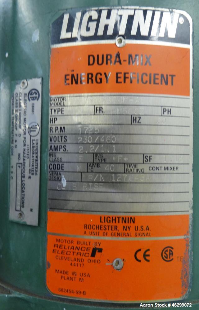 Used Tank, Approximately 350 Gallons, 304 Stainless Steel, Vertical. 60" Diameter x 28" straight side. Bolt-on flat top with 1/3 hinged cover, dished bottom. Top entering Lightnin agitator, model XJC...
