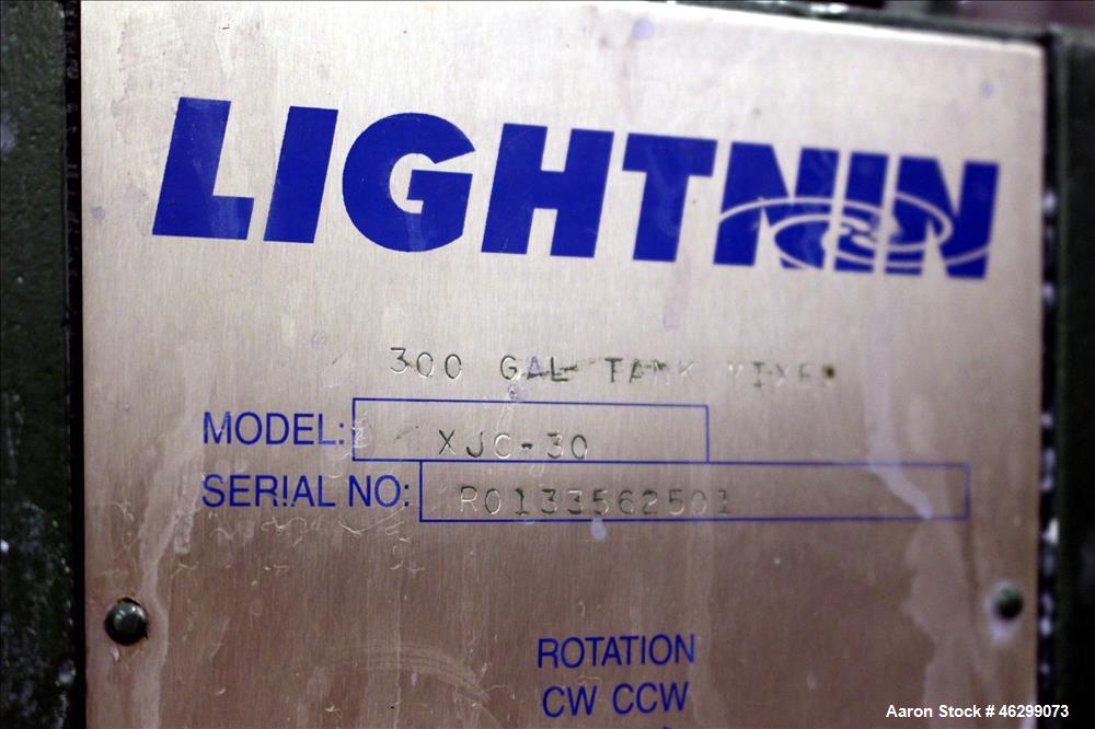 Used Tank, Approximate 350 Gallon, 304 Stainless Steel, Vertical. 60" Diameter x 28" straight side. Bolt on flat top with 1/3 hinged cover, dished bottom. Top entering Lightnin agitator, model XJC-30...