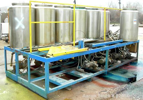 USED: Multi tank feed system consisting of (7) 75 gallon 304 stainless steel tanks, 24" diameter x 36" straight side. Open top with cover, dish bottom. 1" center bottom outlet, (8) 1/2 hp DC gearmoto...