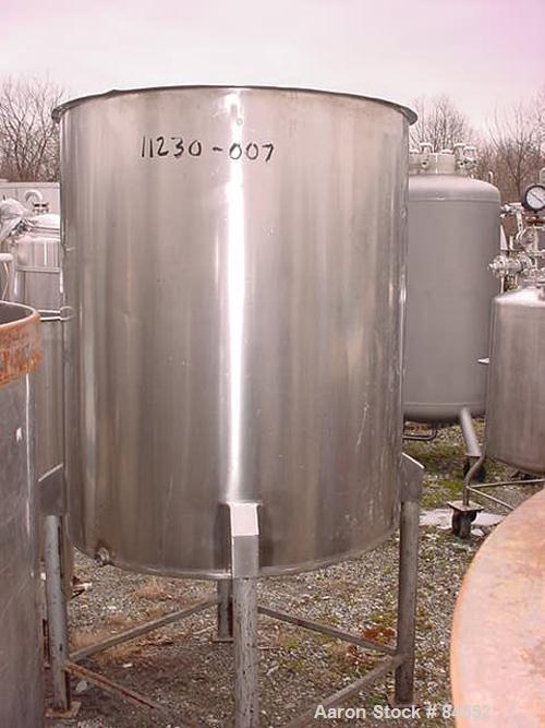 USED: Tank, 250 gallon, stainless steel, vertical. 40" diameter x 48" straight side. Open top, flat bottom. Mounted on four legs.