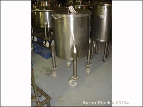 USED: Tank, 60 gallon, stainless steel, vertical. 24" diameter x 28" straight side. Open top with cover, sloped bottom. 1" off center bottom outlet. Mounted on 4 stainless steel legs with casters.