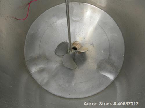Used Coulter tank, 75 gallon, 304 stainless steel, vertical. 26" diameter x 32" straight side, open top a 1 piece 1/3 hinged cover, coned bottom. Includes a shaft with a 3 blade prop, no drive. Appro...