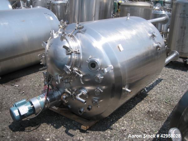 Used DCI tank, 1000 liters (250 gallons) 316L stainless steel constrution, approx. 42" diameter x 36" straight side, dished top and bottom with top entering .5 hp, 15/230 volt Lightnin agitator drive...